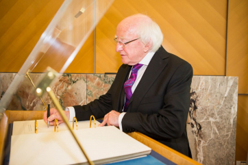 President Higgins signing the ‘Livre d’Or’ (Distinguished Visitors’ Book) at the United Nations Office