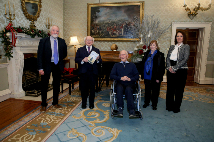 President Higgins receives Mr. John Cameron who presented a copy of his book “Boy 11963”