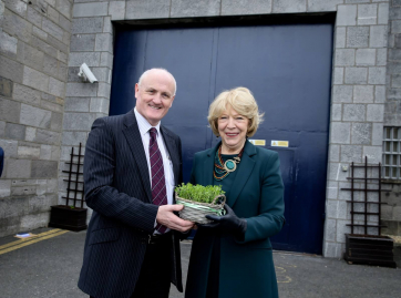 Sabina Higgins presenting a bowl of Shamrock to Arbour Hill Governor Liam Dowling outside the prison