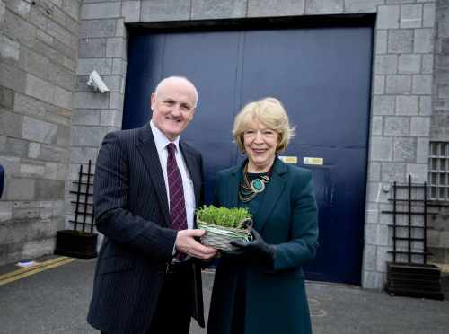 Sabina Higgins presenting a bowl of Shamrock to Arbour Hill Governor Liam Dowling outside the prison