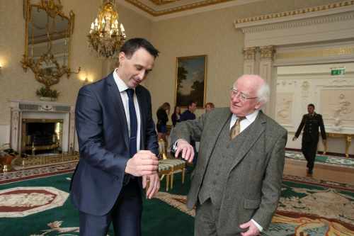 President Michael D.Higgins being shown some moves by Paul Brady, 5 time World Handball Champion.