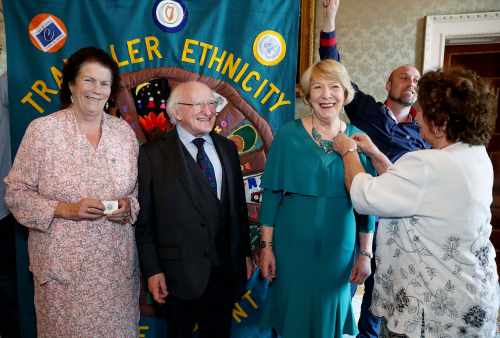 Members of Pavee Point Traveller and Roma Centre present the President with an ethnicity pin