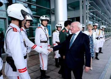 President Michael D. Higgins and his wife Sabina depart Hanoi thanking the motorcycle outriders before traveling to Laos