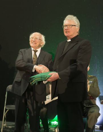 Pictured is President Higgins presented with the Irish Flag from chairperson of the Thomas F Meagher Foundation, Revd Cavanagh.