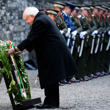 President Higgins laying a wreath at the Easter Sunday Wreath-laying ceremony in Kilmanham Gaol. 