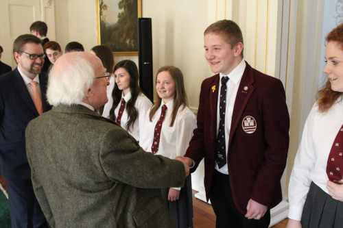 Sam Brodison shakes hands with President Higgins