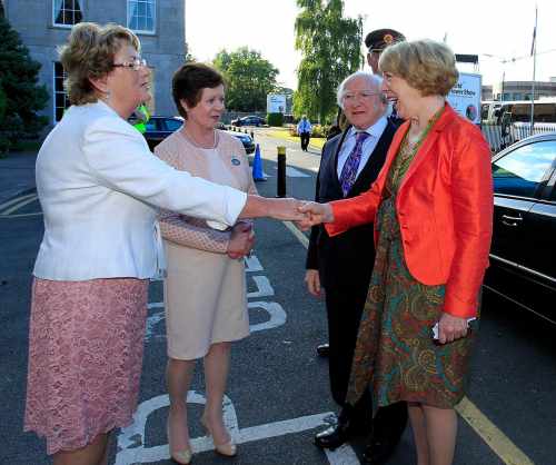President Michael D. Higgins and Sabina Higgins are welcomed to the exhibition by Mary C. O'Keeffe, Vice President of WAFA, and Kitty Gallagher, President of WAFA.